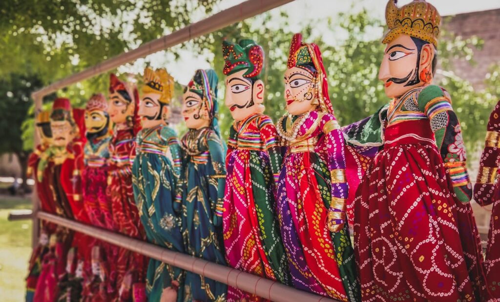 Colorful Rajasthani puppets showcased outdoors, highlighting Indian culture and craftsmanship.